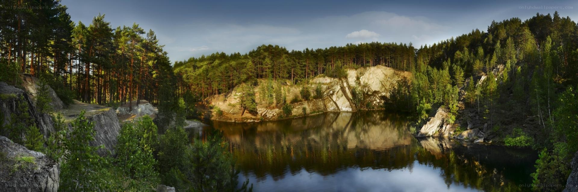 Forest lake with rocky cliffs