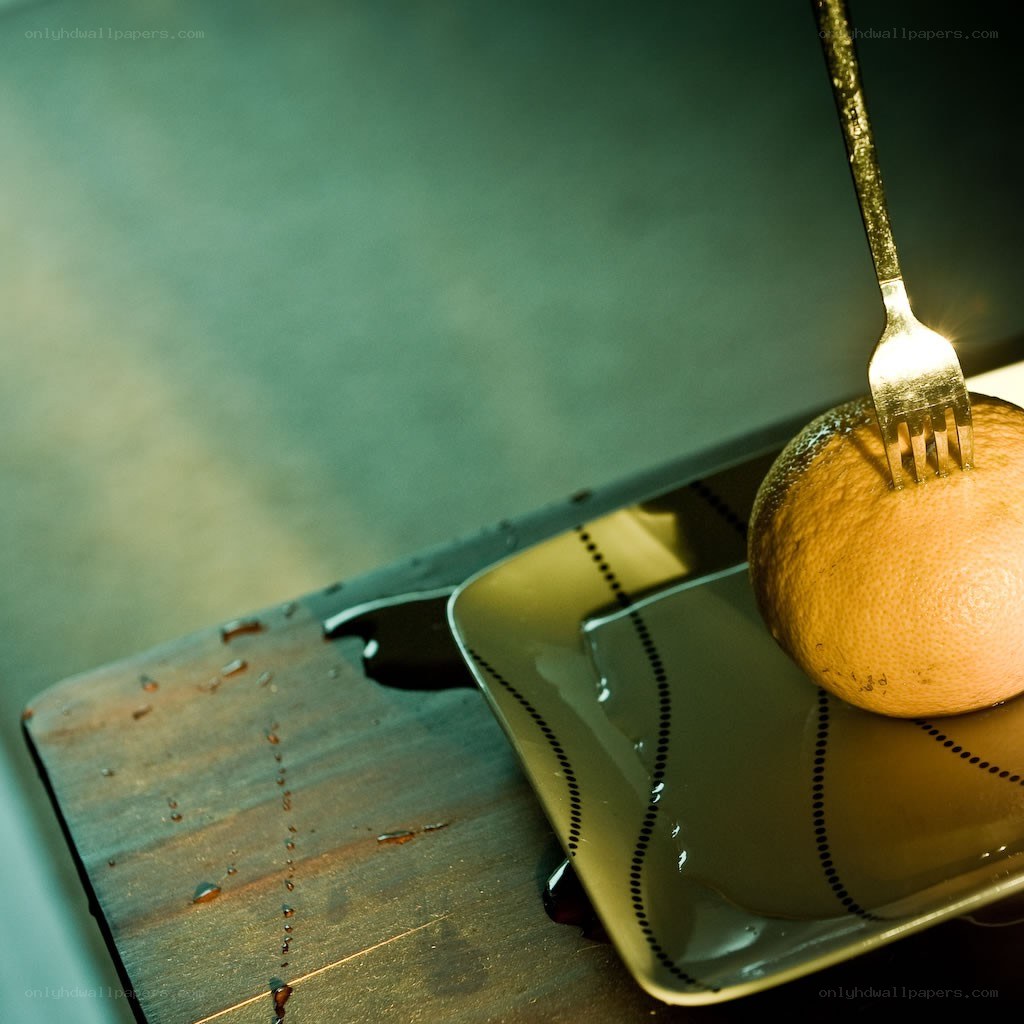 Fork in an orange on a plate