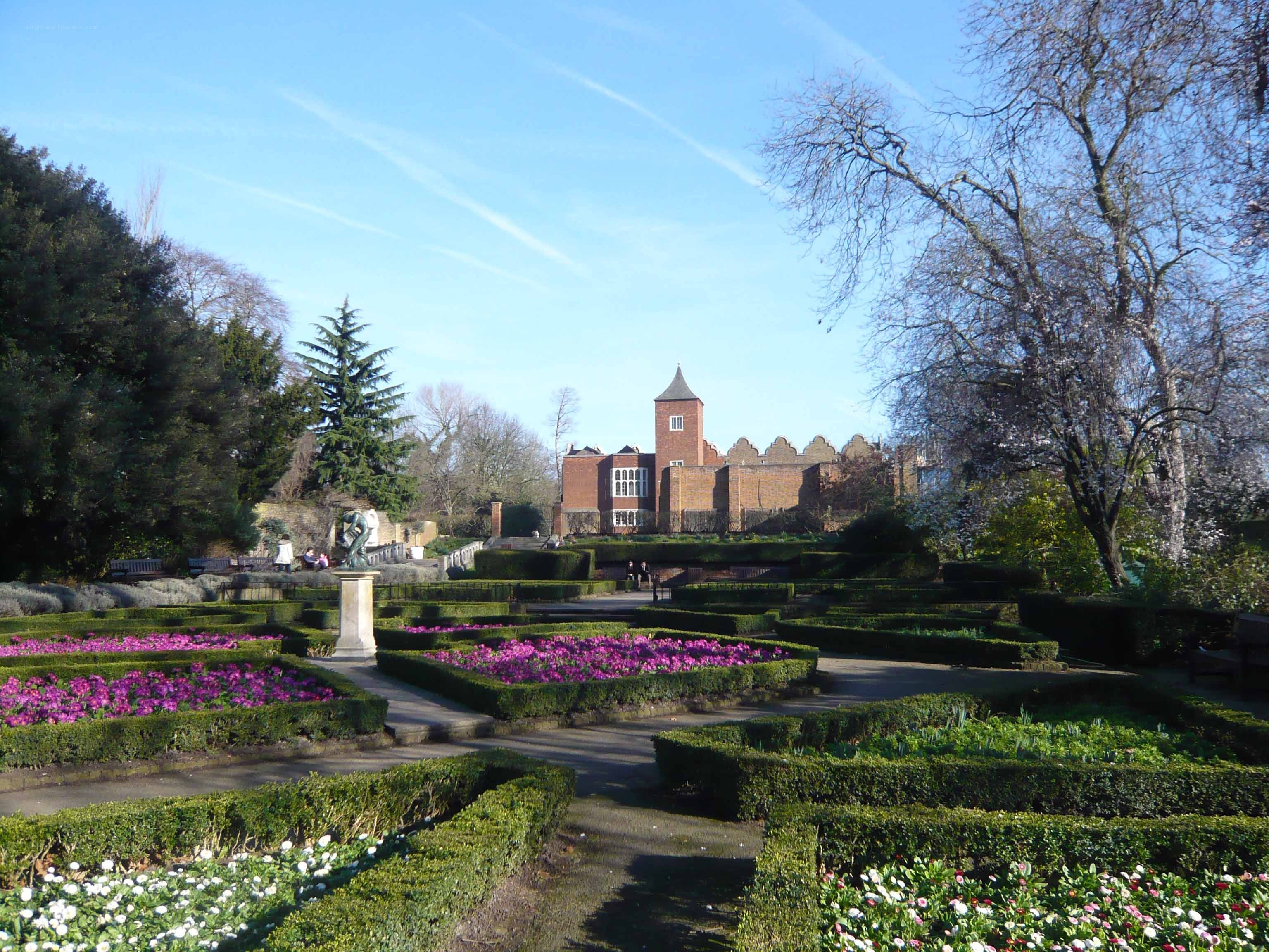 formal garden with brick building