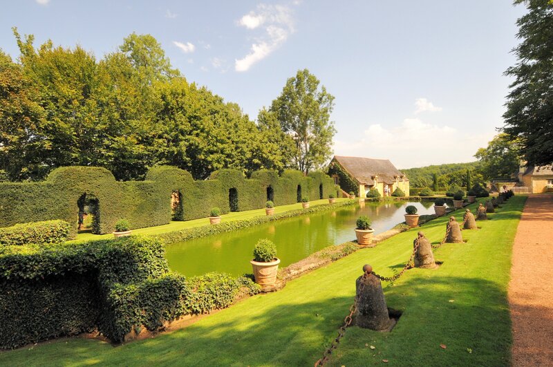 formal garden with canal and house