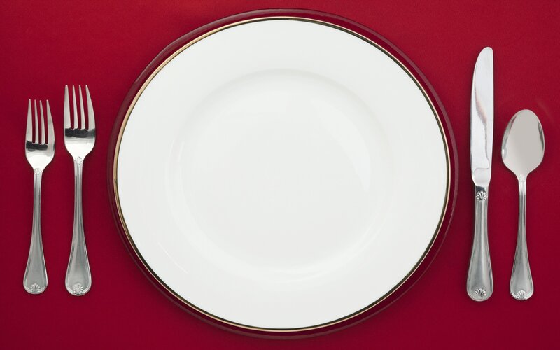 formal place setting on red