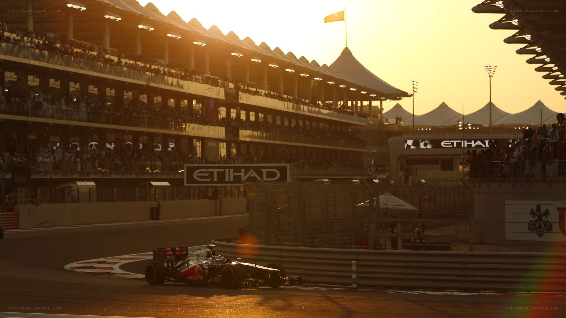 Formula 1 car on track at sunset