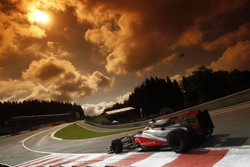 Formula 1 car on track at sunset