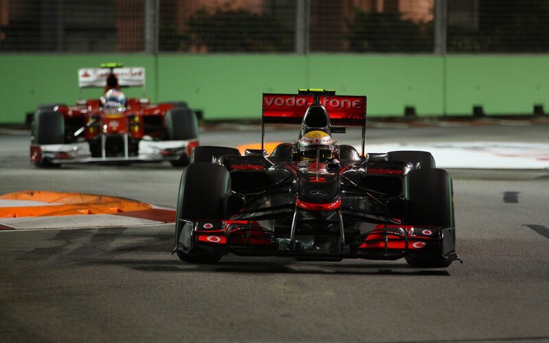 Formula 1 cars racing at night