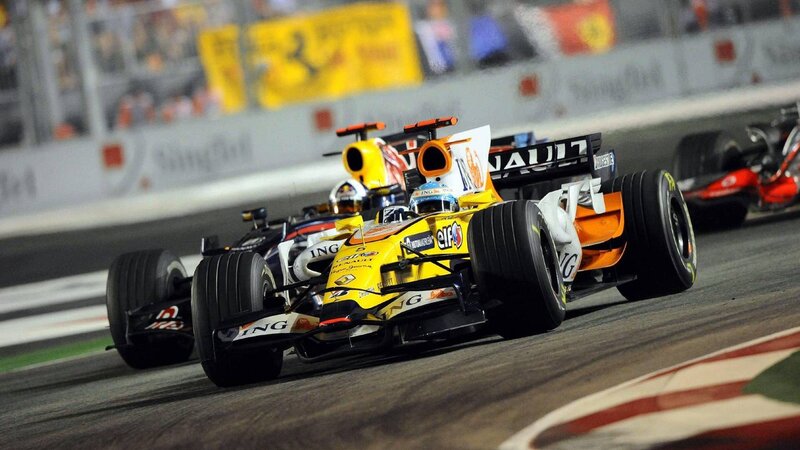Formula 1 cars racing at night