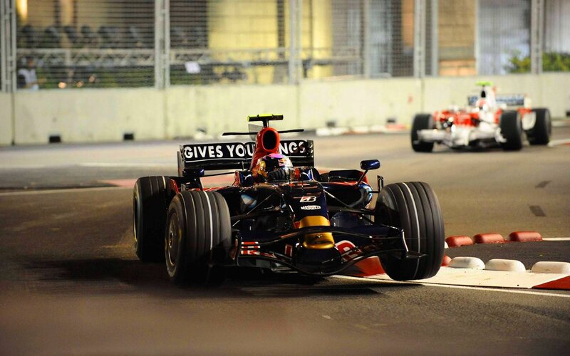 Formula 1 cars racing at night