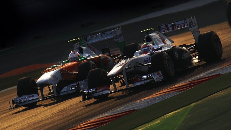 Formula 1 cars racing at night