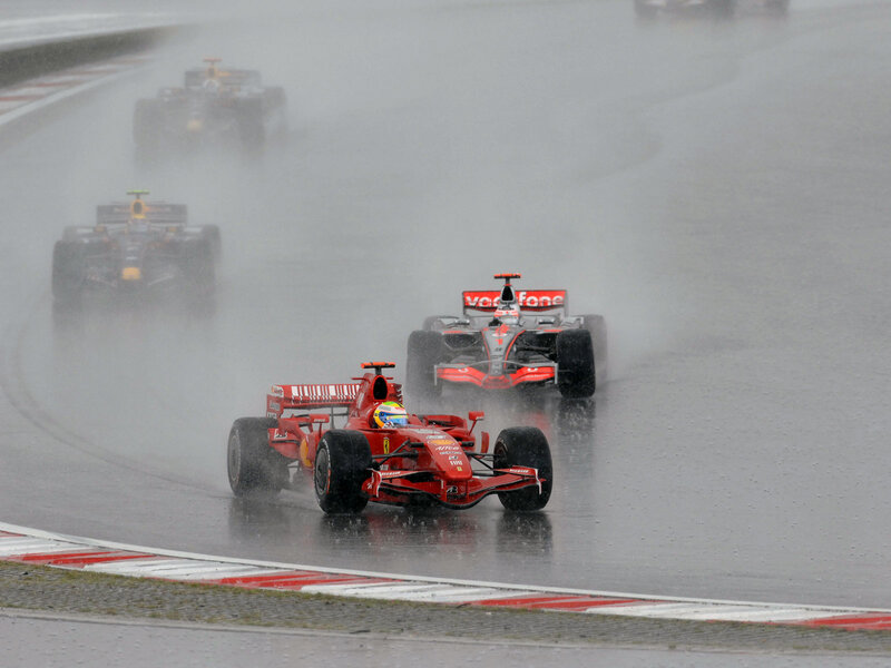 Formula 1 cars racing in rain