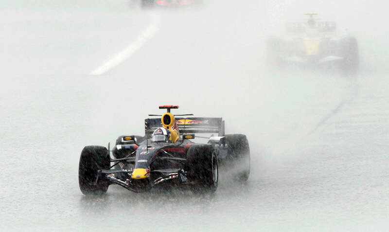 Formula 1 cars racing in rain