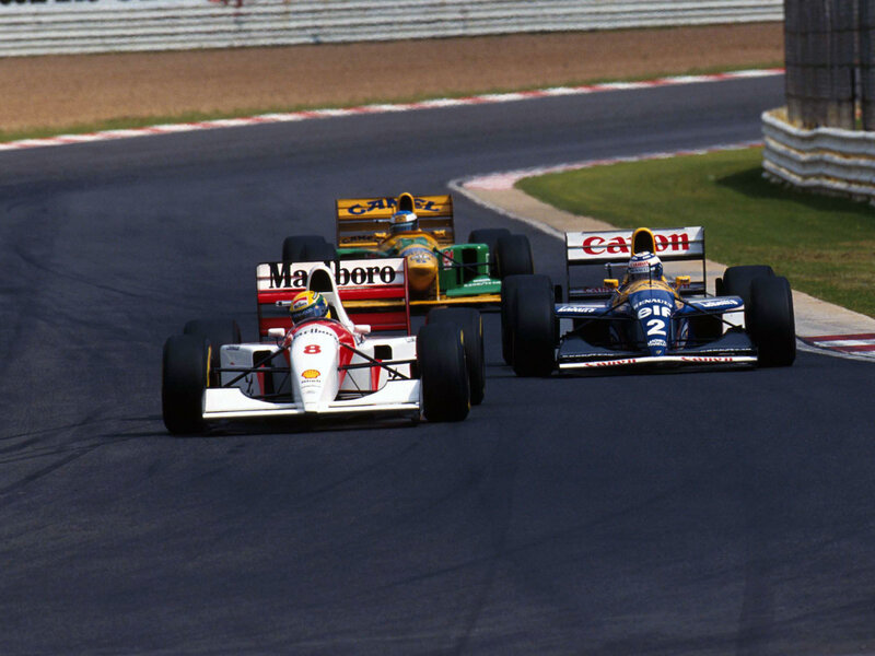 Formula 1 cars racing on track