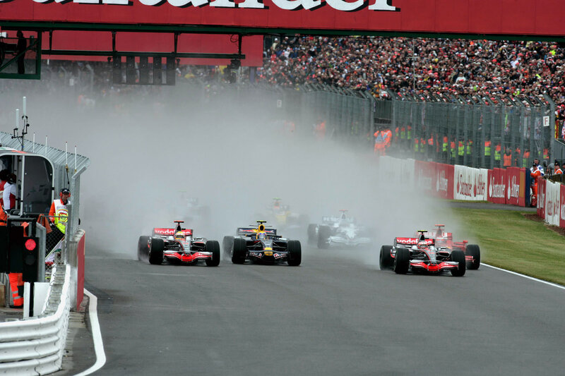 Formula 1 cars racing on wet track