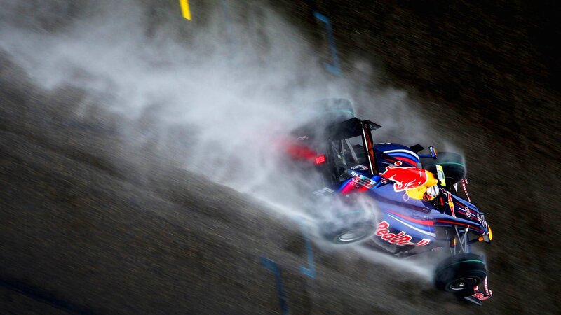 Formula One car drifting in rain
