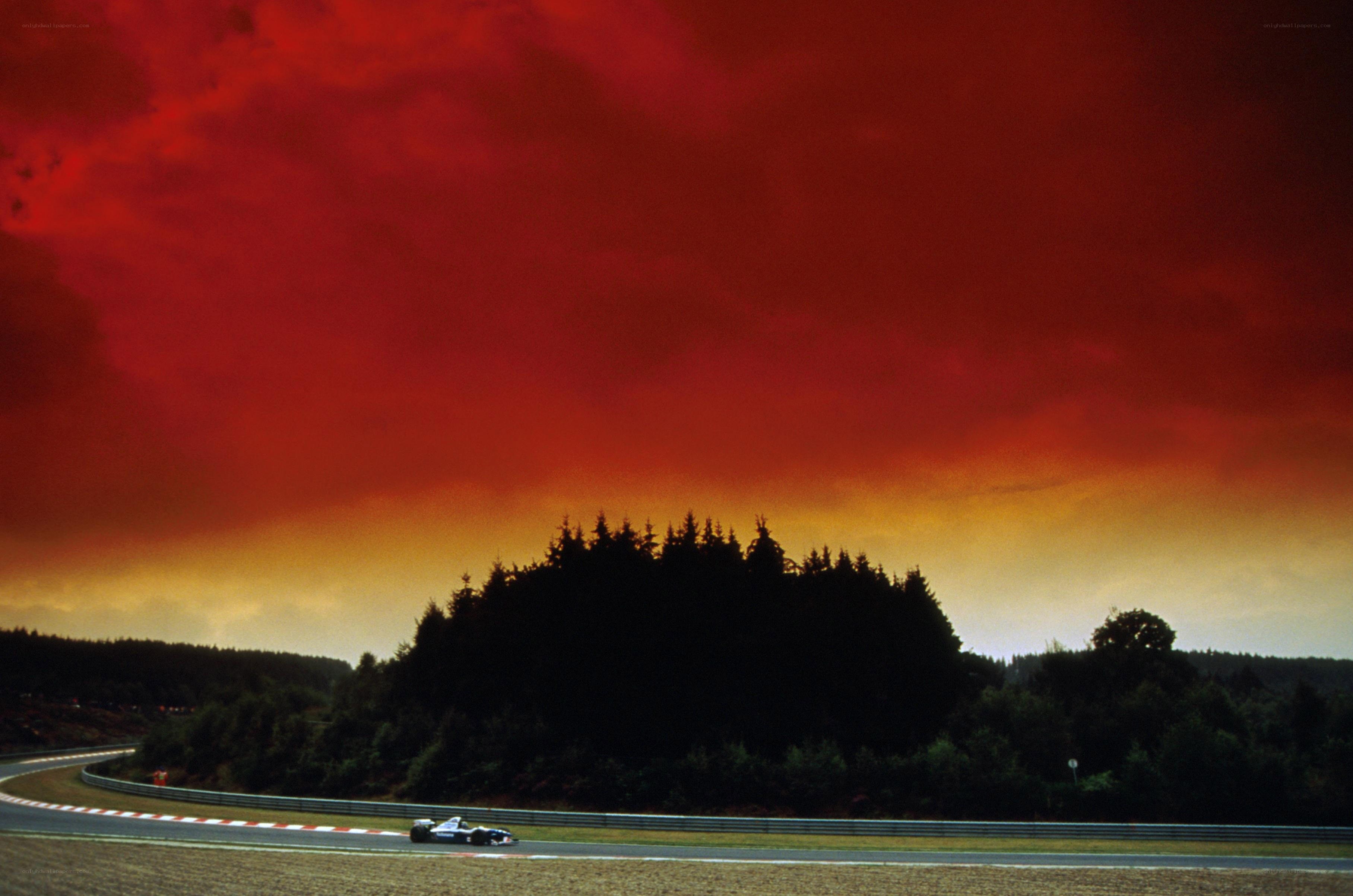 Formula One car on track at sunset