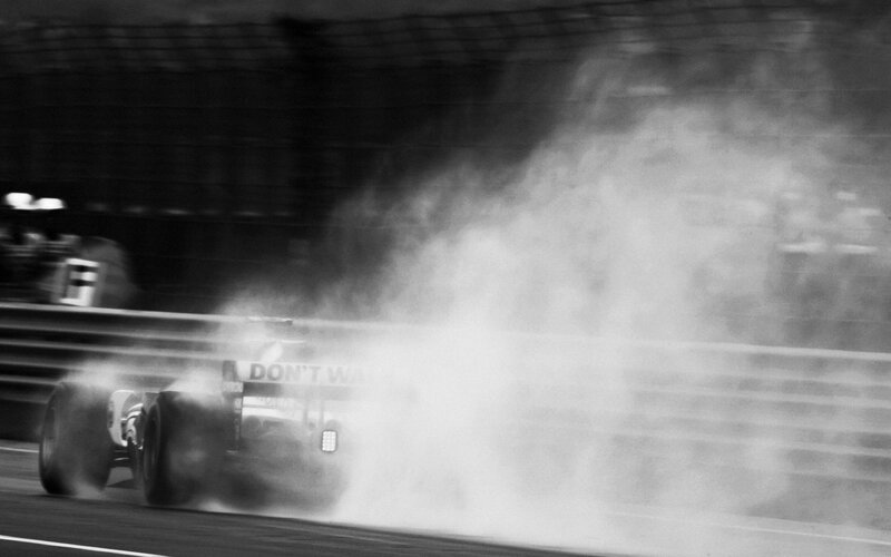 Formula One Car on Track — Black, Dramatic, Photograph, Tire Smoke
