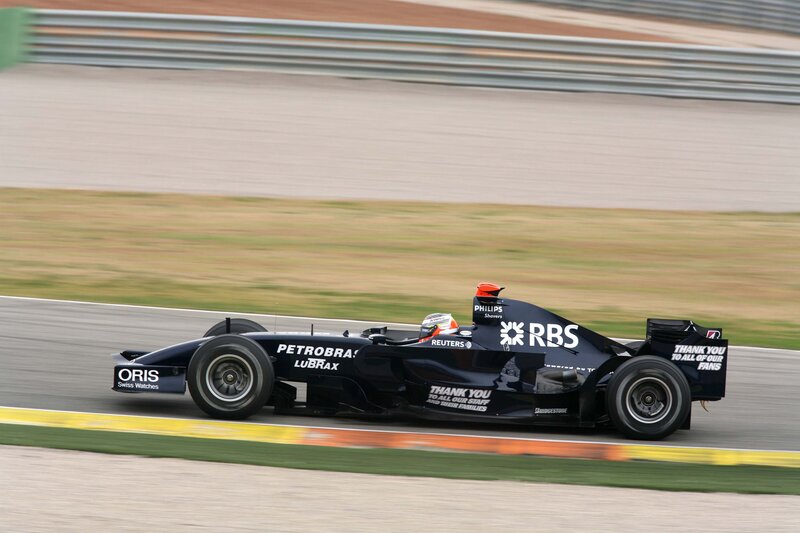 Formula One Car on Track — Black, Dynamic, Afternoon, Photograph, Driver, Racing Circuit, Safety Barrier