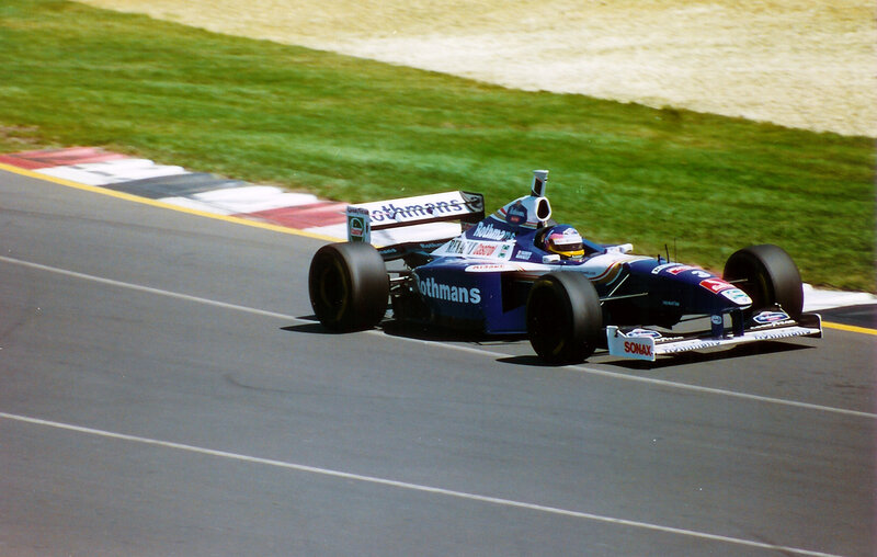 Formula One Car on Track — Blue, Dynamic, Afternoon, Photograph, Driver, Grass