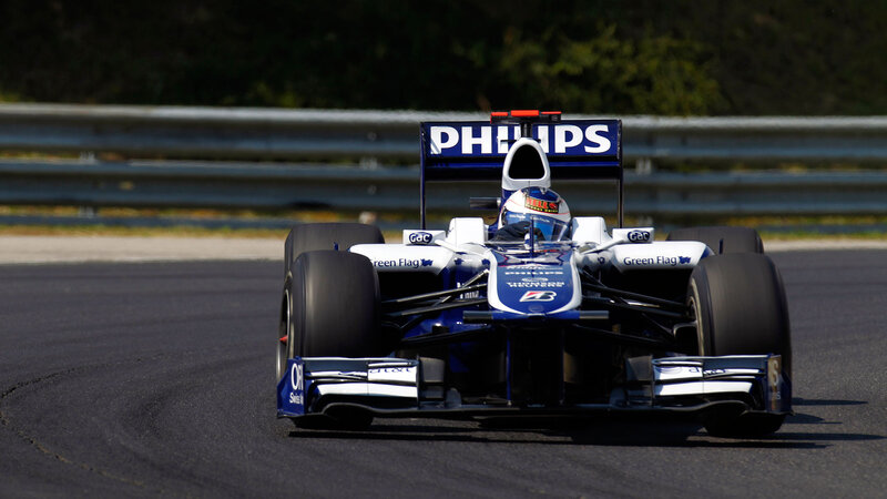 Formula One Car on Track — Blue, Dynamic, Afternoon, Photograph, Driver, Race Car, Guardrail