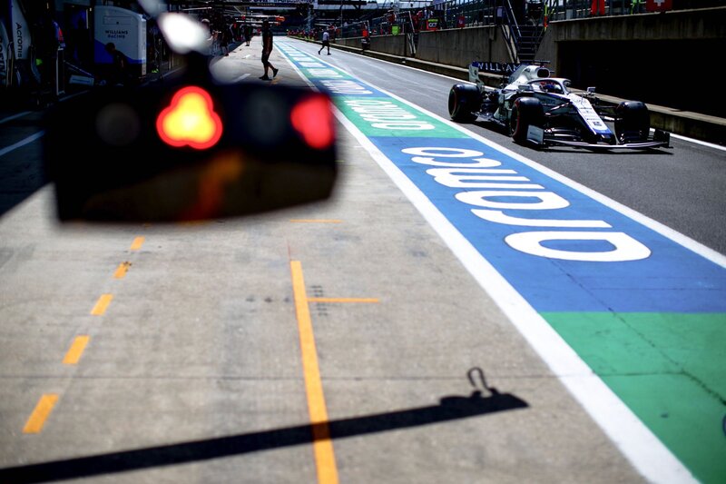 Formula One Car on Track — Blue, Dynamic, Afternoon, Photograph, Race Car, Pit Lane