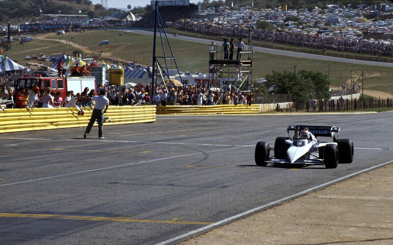 Formula One Car on Track — Gray, Active, Afternoon, Photograph, Crowd, Fire Truck