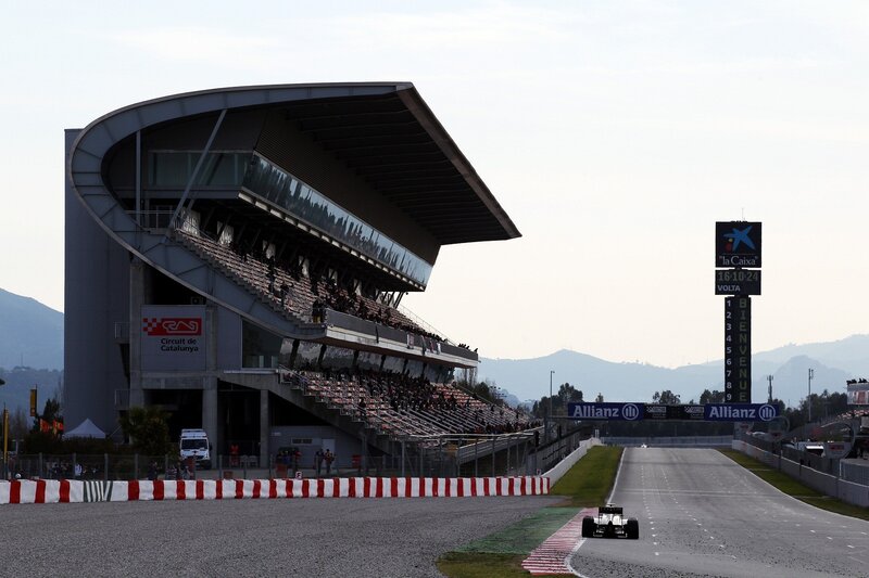 Formula One Car on Track — Gray, Calm, Afternoon, Photograph, Grandstand