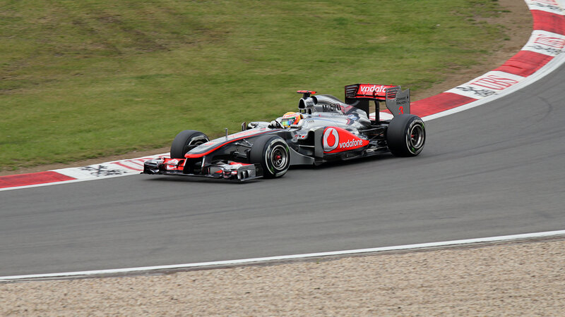 Formula One Car on Track — Gray, Dynamic, Afternoon, Photograph, Driver, Grass