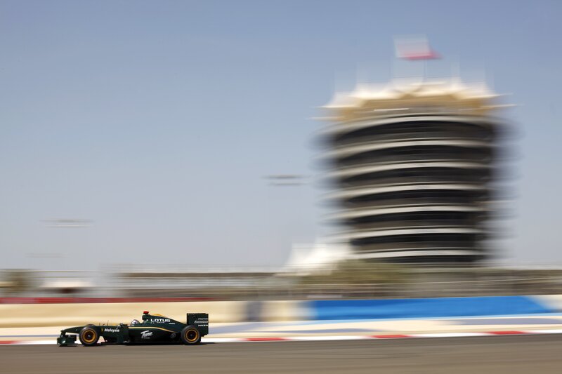 Formula One Car on Track — Green, Dynamic, Afternoon, Photograph, Race Car, Tower