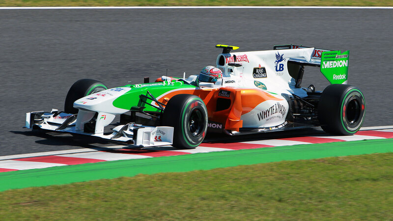 Formula One Car on Track — Green, Dynamic, Afternoon