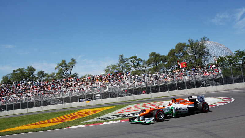 Formula One Car on Track — Orange, Active, Afternoon