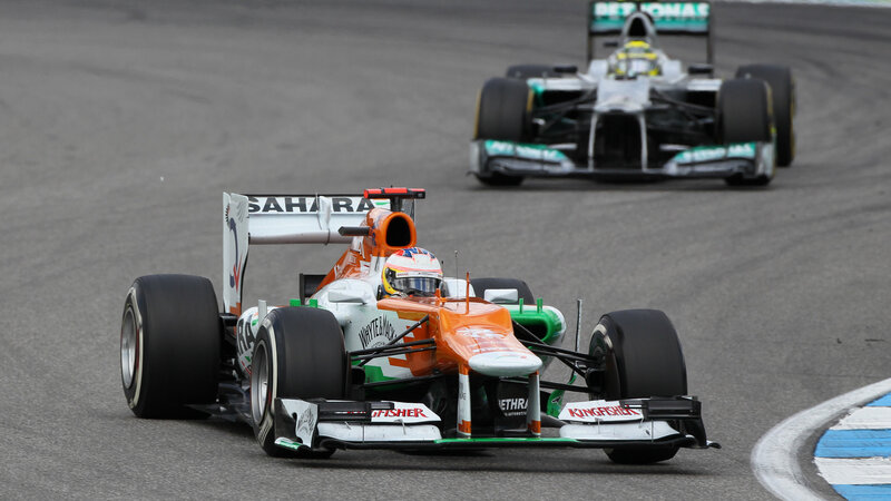 Formula One Car on Track — Orange, Competitive