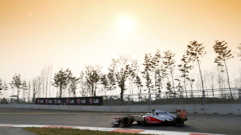 Formula One Car on Track — Orange, Dramatic, Sunset