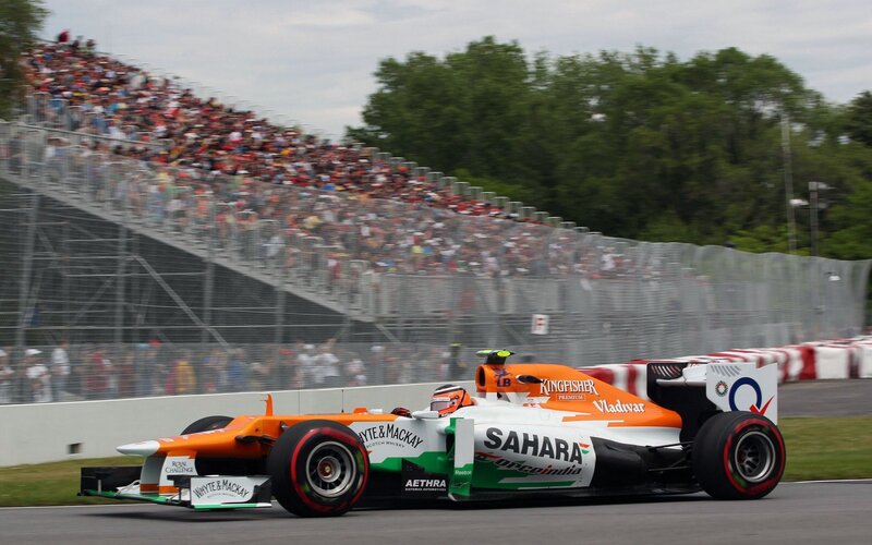 Formula One Car on Track — Orange, Dynamic, Afternoon, Photograph, Crowd