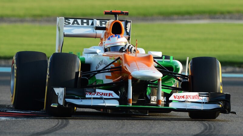 Formula One Car on Track — Orange, Dynamic, Afternoon, Photograph, Driver, Racing Car, Grass