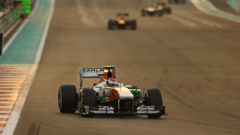 Formula One Car on Track — Orange, Dynamic, Sunset