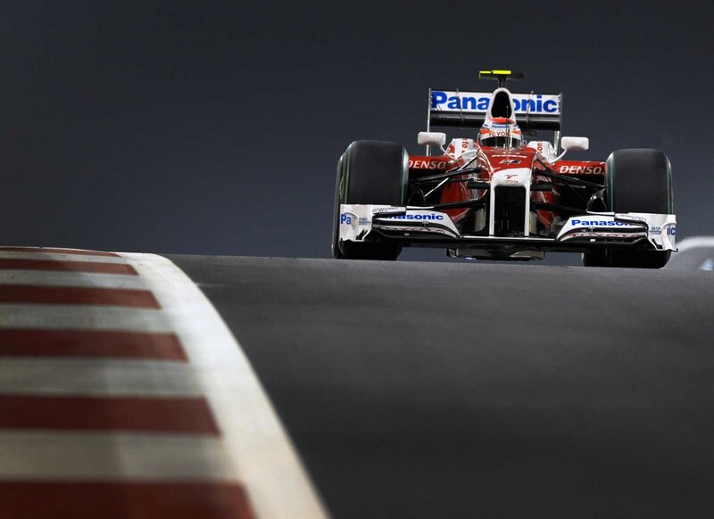 Formula One Car on Track — Red, Dramatic, Night