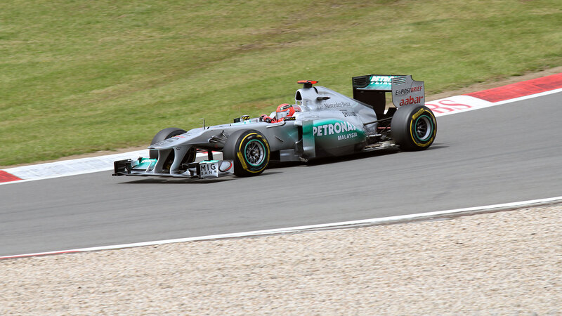 Formula One Car on Track — Silver, Dynamic, Afternoon, Photograph, Driver, Grass, Gravel