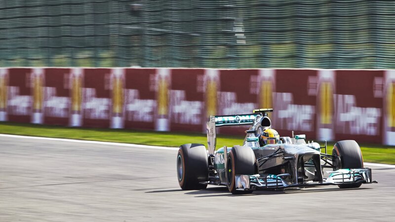 Formula One Car on Track — Silver, Dynamic, Afternoon, Photograph, Driver, Wall