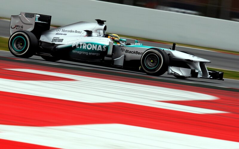 Formula One Car on Track — Silver, Dynamic, Photograph, Driver, Race Track, Safety Barrier