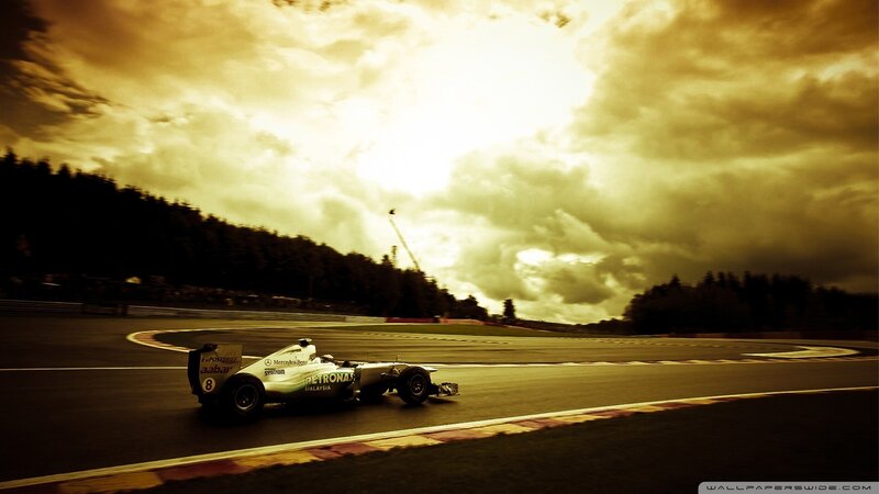 Formula One Car on Track — Yellow, Dramatic, Sunset, Photograph, Race Car, Clouds