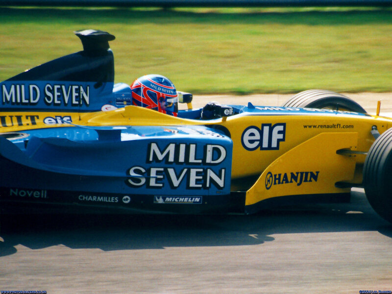 Formula One Car on Track — Yellow, Dynamic, Afternoon, Photograph, Driver, Racing Car, Grass