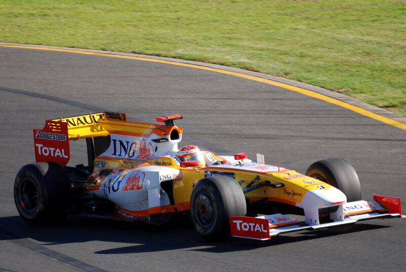Formula One Car on Track — Yellow, Dynamic, Afternoon, Photograph, Driver
