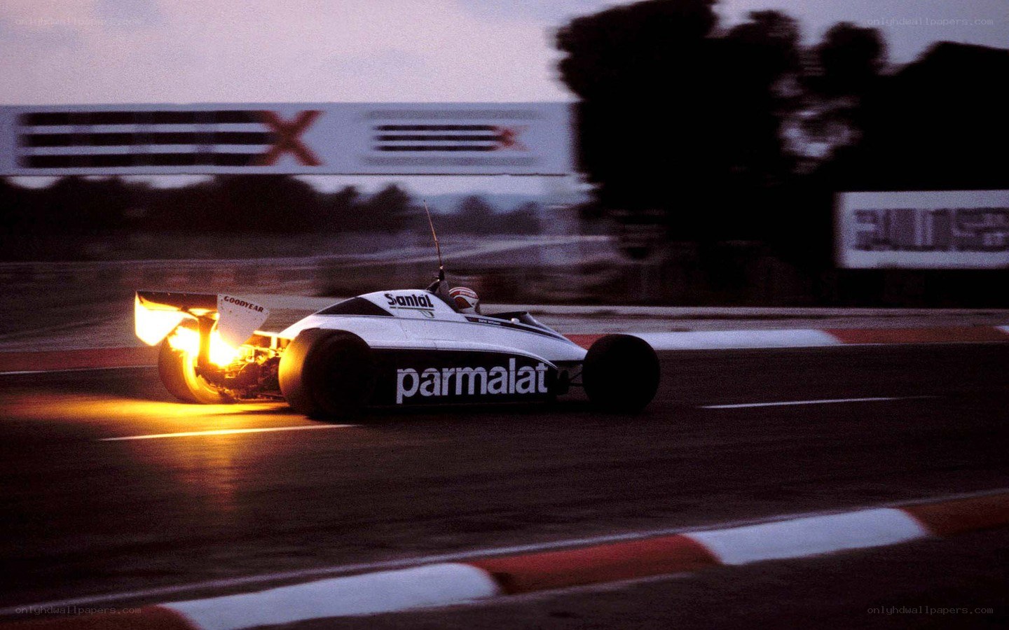 Formula One car racing at dusk