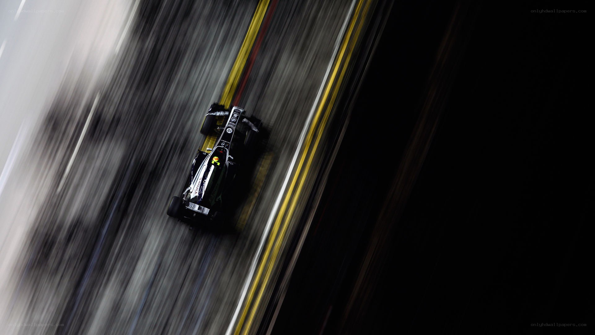 Formula One car racing at night