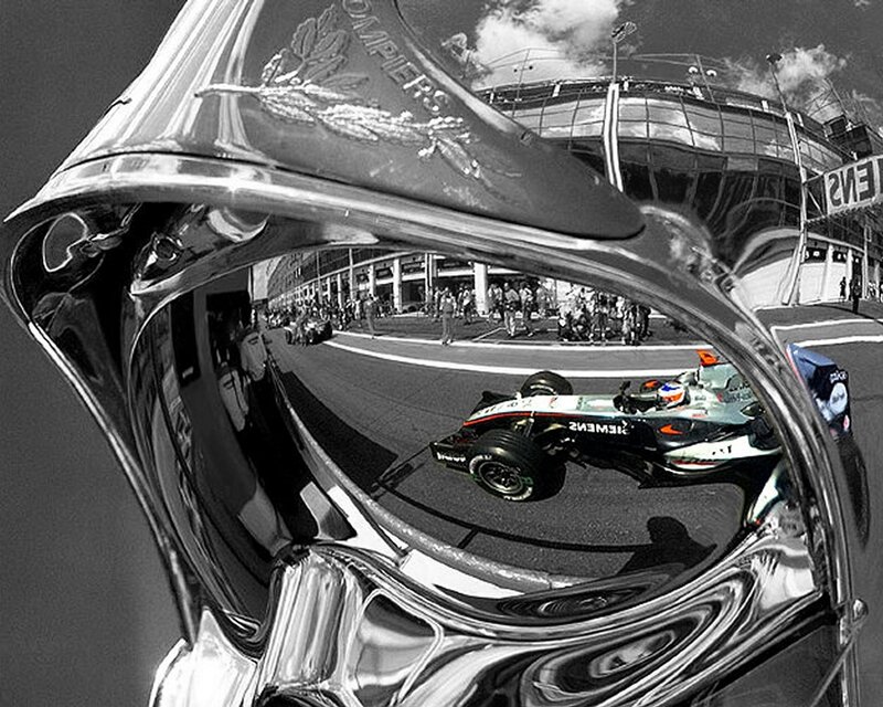 Formula One car reflected in a trophy