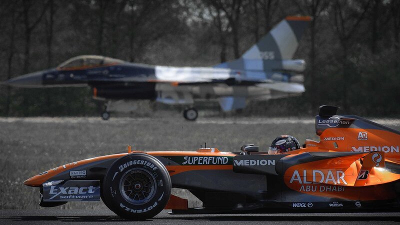 Formula One car with jet in background