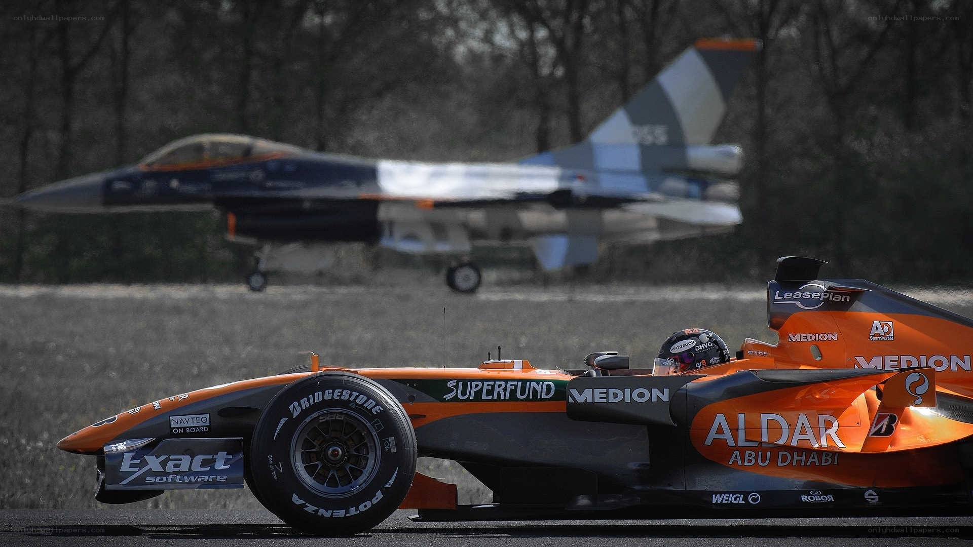 Formula One car with jet in background