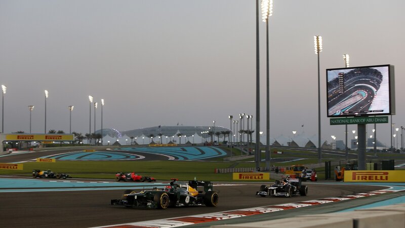 Formula One Cars on Track — Black, Competitive, Sunset