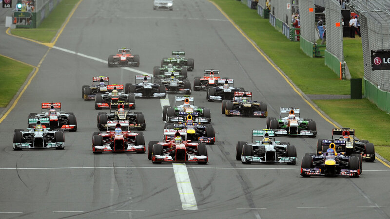 Formula One Cars on Track — Gray, Competitive, Afternoon, Photograph, Race Cars, Spectators, Fencing