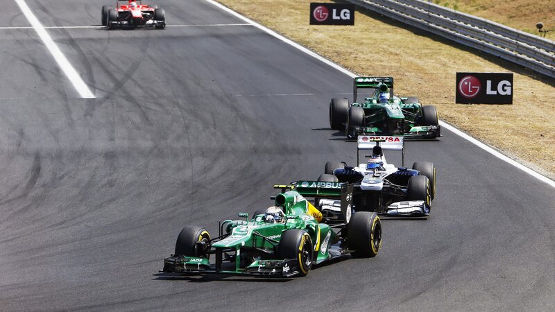 Formula One Cars on Track — Green, Competitive, Afternoon