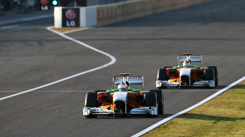 Formula One Cars on Track — Orange