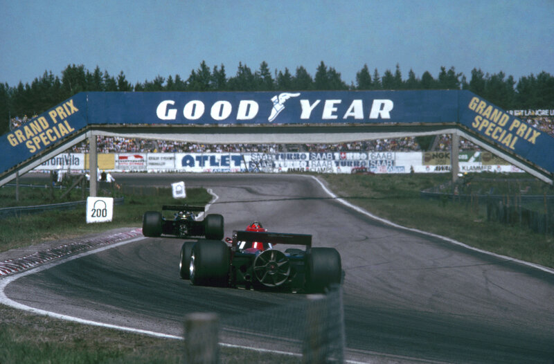 Formula One cars racing at a track